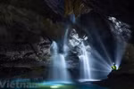 Exploring waterfall in million-year-old cave