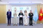 A police officer receives a certificate after attending the training programme in Hanoi. (Photo: VNA)