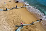 Fishermen pull in nets in Da Nang city