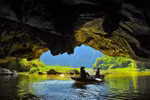 The caves are surrounded by the Ngo Dong River and rice fields stretching along the foot of the mountains, immersing visitors in the surrounding nature. (Photo: VietnamPlus)