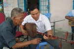 Khmer youths learn to play traditional musical instrument 