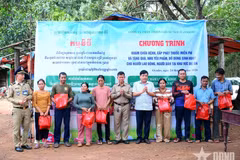 Col. Ha Van Nam, Secretary of the Party Committee and Deputy Commander of Economic-Defence Unit 74, and representatives of the Oyadav district authorities and Cambodian armed forces present gifts to local residents. (Photo: qdnd.vn) 