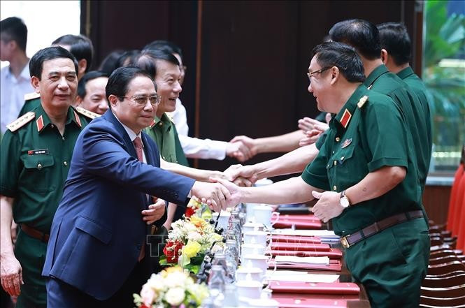 Prime Minister Pham Minh Chinh (front, left) attends the national military-political conference on July 2. (Photo: VNA)
