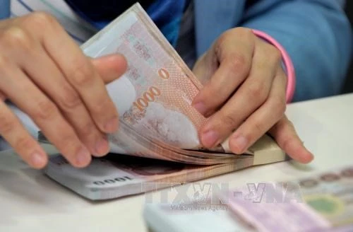 Thailand's Ministry of Finance is mulling amending tax laws on income from foreign investments to create a more favourable environment for investors and lure Thais to repatriate their earnings. (Photo: AFP/VNA)