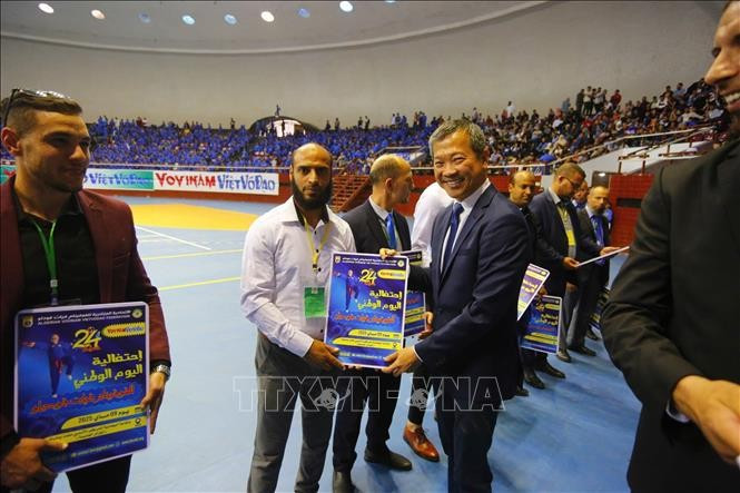 President of the World Vovinam Federation (WVVF) Mai Huu Tin is with outstanding sponsors and coaches at Vovinam Day in Algeria, taking place on May 9. (Photo: published by VNA)