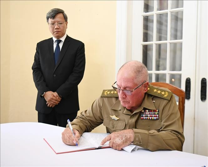 Minister of the Cuban Ministry of the Revolutionary Armed Forces Senior Lieutenant General Alvaro Lopez Miera writes in the condolence book at the Vietnamese Embassy in Cuba. (Photo: VNA)