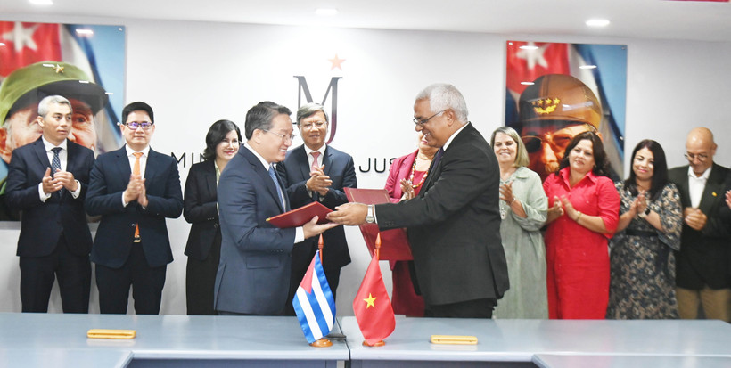 Visiting Vietnamese Minister of Justice Nguyen Hai Ninh (L) and his Cuban counterpart Oscar Manuel Silvera Martínez exchange documents after signing an agreement on a technical assistance project for the Cuban Ministry of Justice. (Photo: VNA)