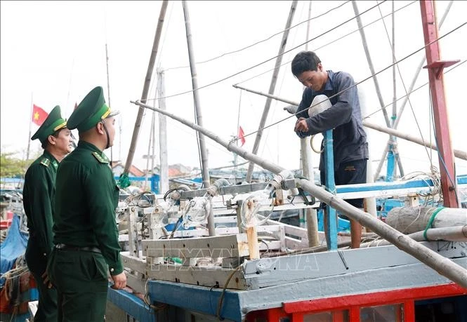 Border guards in Phu Yen province disseminate anti-IUU fishing information to a fisherman at the Dong Tac fishery port in Tuy Hoa city. (Photo: VNA)