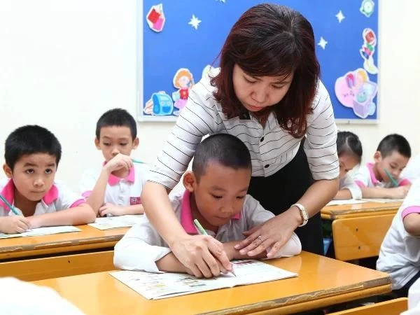 Students from kindergarten to high school in the public school system nationwide will be exempt from tuition fees from the start of the next school year. (Photo: VNA) 