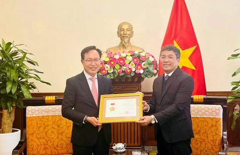 Permanent Deputy Minister of Foreign Affairs Nguyen Minh Vu (right) awards the For the Cause of Vietnam’s Foreign Affairs insignia to General Director of Samsung Vietnam Choi Joo Ho on February 13. (Photo: VNA)