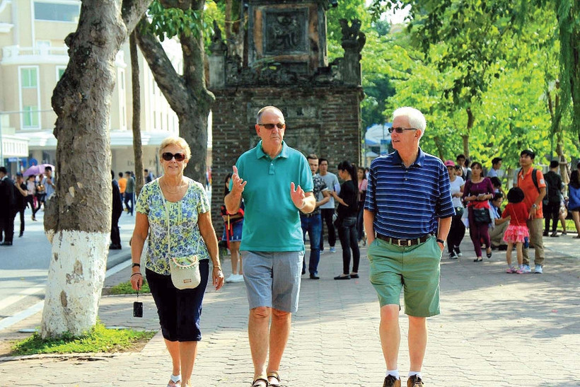 Foreign tourists captured walking around Hoan Kiem Lake in Hanoi. (Photo: VNA)