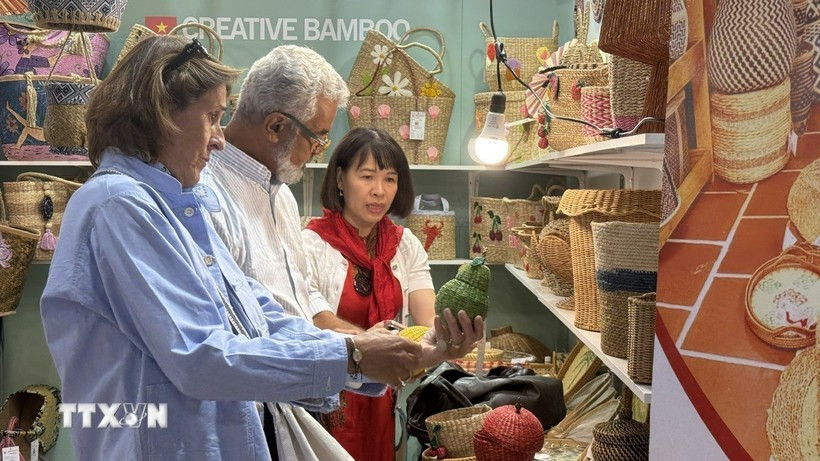 Customers explore products at a Vietnamese enterprise’s booth. (Illustrative photo: VNA)