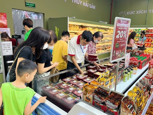 Customers shop for meat products at a supermarket in Hanoi. (Photo: VNA)