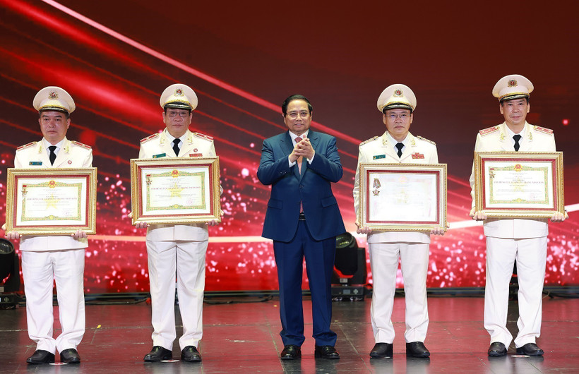 Prime Minister Pham Minh Chinh (middle) presents the Hero of the People’s Armed Forces title to outstanding individuals and collectives of the the People’s Public Security force. (Photo: VNA)