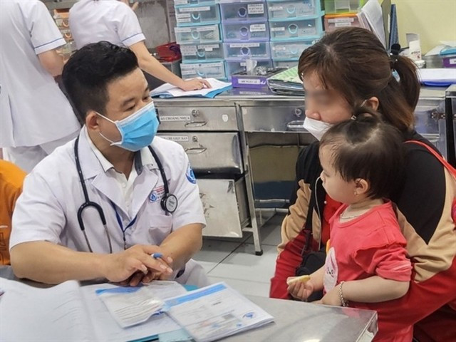 A doctor examines a child during a medical check-up in HCM City. (Photo: VNA)