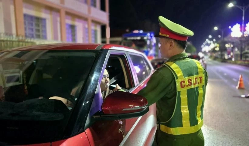 A traffic police in Gia Lai checks the alcohol concentration of a driver. (Photo: VNA)