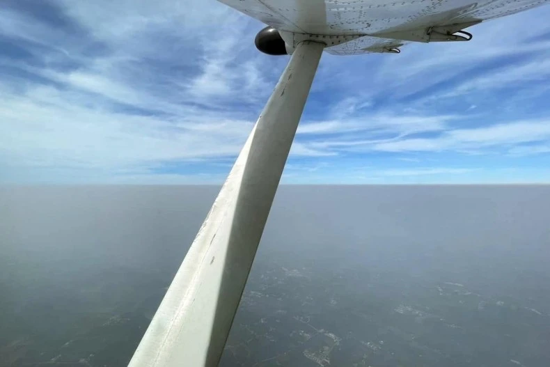 The view from a light aircraft taking part in an anti-pollution operation over Samut Sakhon, which also helps combat haze pollution in Bangkok. (Photo: Department of Royal Rainmaking and Agricultural Aviation)