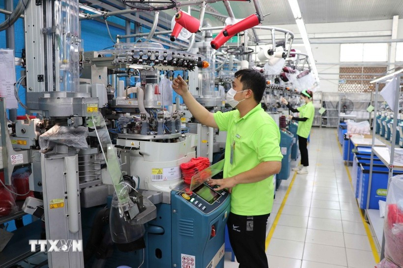 Workers operate machinery at the Sung Hwa Vina factory, a Korean-invested enterprise in Hoa Binh Industrial Park, Tay Ninh province. (Photo: VNA)