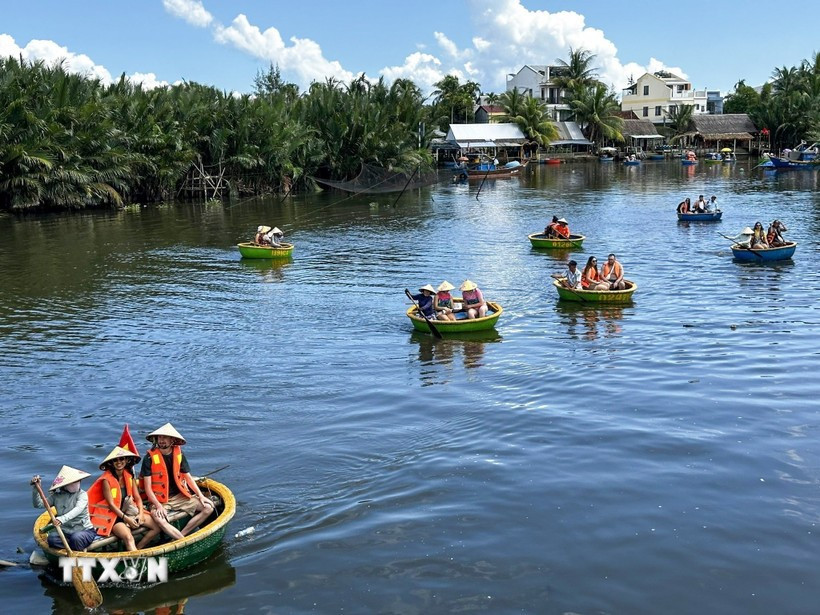 Tourists experience bamboo basket boat tours in Bay Mau nipa palm forest (Photo: VNA)