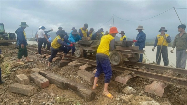 Workers repair the railway sections damaged by the flood. (Photo courtesy of the Vietnm Railways)