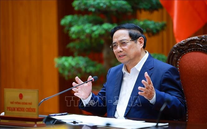 Prime Minister Pham Minh speaks at the working session. (Photo: VNA)