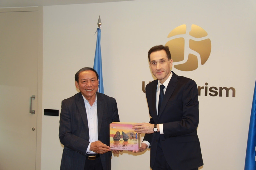 Minister of Culture, Sports and Tourism Nguyen Van Hung (left) presents a gift to Beka Jakeli, Chief of External Relations at UN Tourism. (Photo published by VNA)