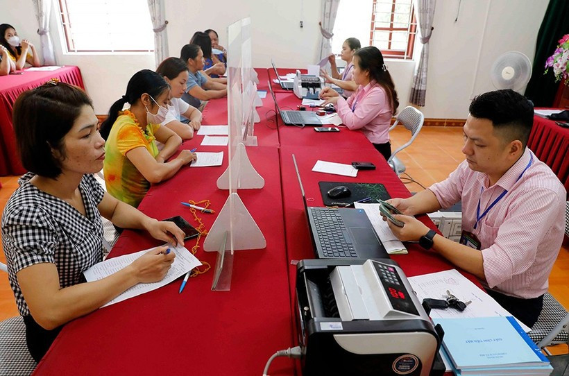 Immediately after the official launch of the two-tier local government model on July 1, the Vietnam Bank for Social Policies directed its provincial and municipal branches to promptly ensure convenient and seamless disbursement for the public. (Photo: VietnamPlus)
