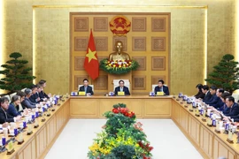 PM Pham Minh Chinh (centre) chairs the dialogue. (Photo: VNA)