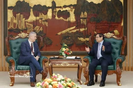 Prime Minister Pham Minh Chinh (R) receives Belgian Ambassador to Vietnam Karl Van Den Bossche on February 26. (Photo: VNA)