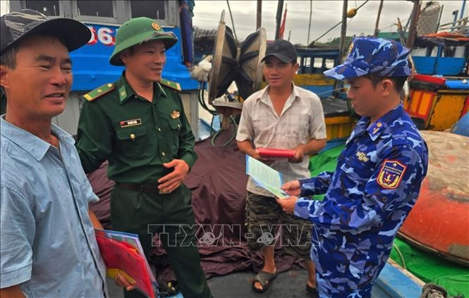 Officers of Coast Guard Region 2 disseminate legal regulations on fisheries to fishermen. (Photo: VNA)