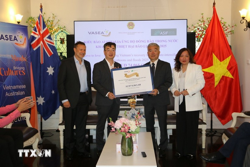 VASEA President Professor Nghiem Duc Long (second, left) presents a token donation for flood-affected compatriots to Nguyen Thanh Tung, Vietnamese Consul General in Sydney. (Photo: VNA) 