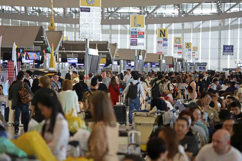 Outbound travellers are pictured at the passenger terminal of Suvarnabhumi airport during the Songkran festival last year. (Photo: Bangkokpost) 
