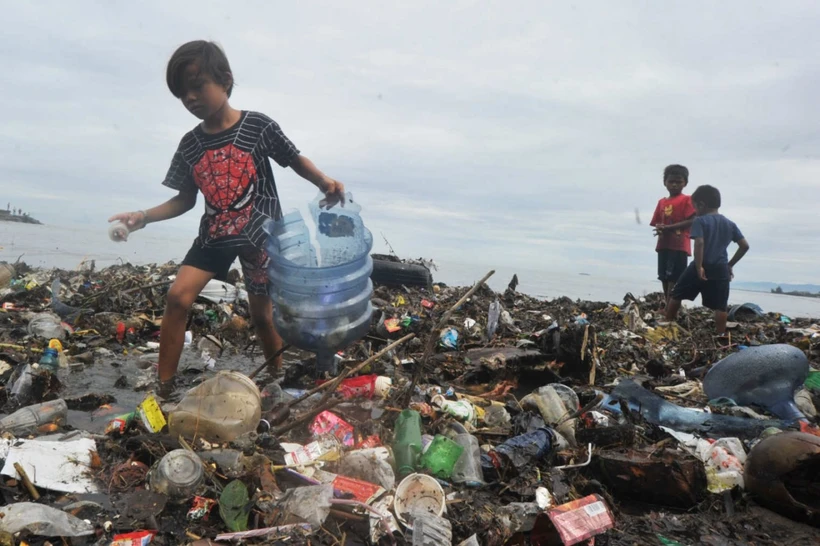 Children collect trash on July 9, 2020, at Muaro Lasak Beach, Padang, West Sumatra. Then Environment and Forestry minister Siti Nurbaya Bakar said that waste accumulation in 2020 was estimated to reach 67.8 million tonnes. (Photo: Antara) 