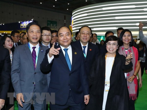 PM attends opening of China International Import Expo ảnh 1