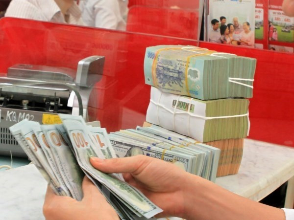Reference exchange rate down 21 VND on March 12 ảnh 1