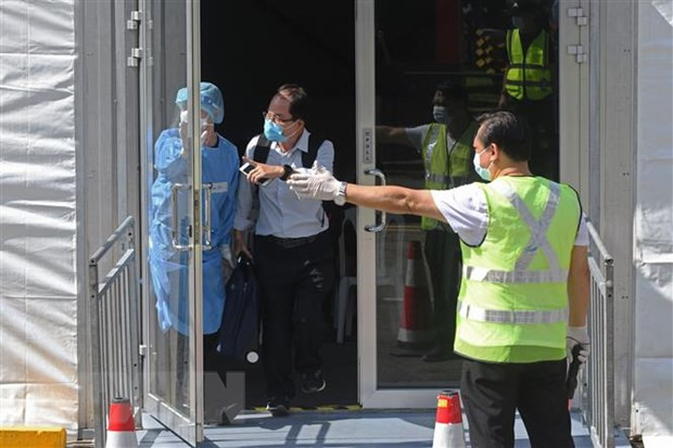 Singapore issues new measures for managing Omicron variant cases ảnh 1