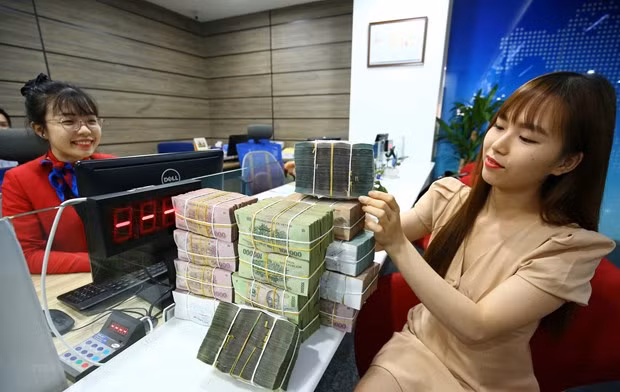 Reference exchange rate down 21 VND on July 19 ảnh 1
