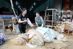 Residents in Yen Binh commune, Lang Son province, cleans up their houses and assets after floods. (Photo: VNA)