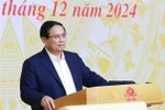 Prime Minister Pham Minh Chinh speaks at the national conference in Hanoi on December 25 on the implementation of the laws and resolutions passed by the 15th National Assembly (NA) at its eighth session. (Photo: VNA)