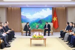 Prime Minister Pham Minh Chinh (right) receives Rosatom Director General Alexey Likhachev in Hanoi on January 13. (Photo: VNA)