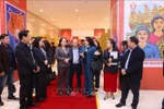 Deputy General Director of the Vietnam News Agency (VNA) Nguyen Thi Su introduces the VNA photo exhibition area at the 11th National Patriotic Emulation Congress to Vice State President Vo Thi Anh Xuan. (Photo: VNA)