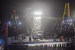 At 2:00 a.m. on July 20, rescue teams begin pumping water out of the capsized tourist boat before towing it ashore. (Photo: VNA)