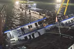 The capsized Vinh Xanh 58 tourist boat is salvaged and towed ashore early July 20 for further investigation. (Photo: VNA)