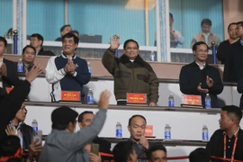 Prime Minister Pham Minh watches the match between Vietnam and Myanmar, giving encouragement to Vietnamese players. (Photo: VNA)