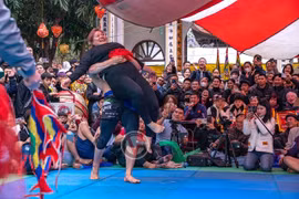 Zakhar Dzmitrychenka lifts Nguyen Thi Thanh Truc during their wrestling match in Trieu Khuc Villages Festival. (Photos of Grappling Vietnam) 