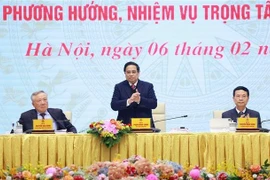 Prime Minister Pham Minh Chinh (standing) at the 10th nationwide online session of the National Committee for Digital Transformation in Hanoi on February 6. (Photo: VNA)