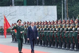 Party General Secretary To Lam (right), who is also Secretary of the Central Military Commission, review the guard of honour during his working visit to Military Region 7 on January 8. (Photo: VNA)