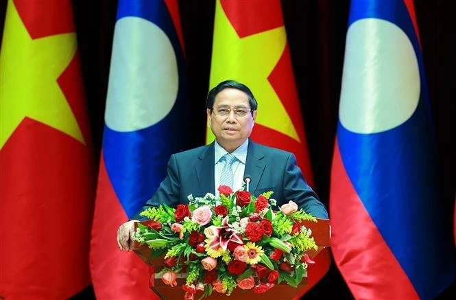 Prime Minister Pham Minh Chinh speaks at the investment cooperation conference in Vientiane on January 9. (Photo: VNA)