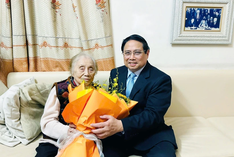 Prime Minister Pham Minh Chinh visits former Vice President Nguyen Thi Binh on March 8. (Photo: VNA)