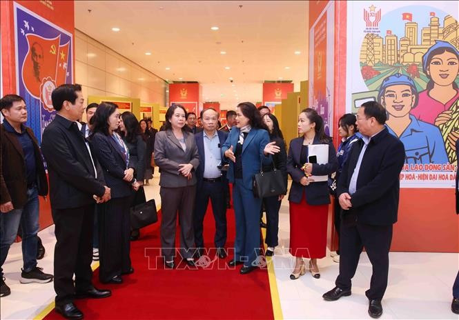 Deputy General Director of the Vietnam News Agency (VNA) Nguyen Thi Su introduces the VNA photo exhibition area at the 11th National Patriotic Emulation Congress to Vice State President Vo Thi Anh Xuan. (Photo: VNA)